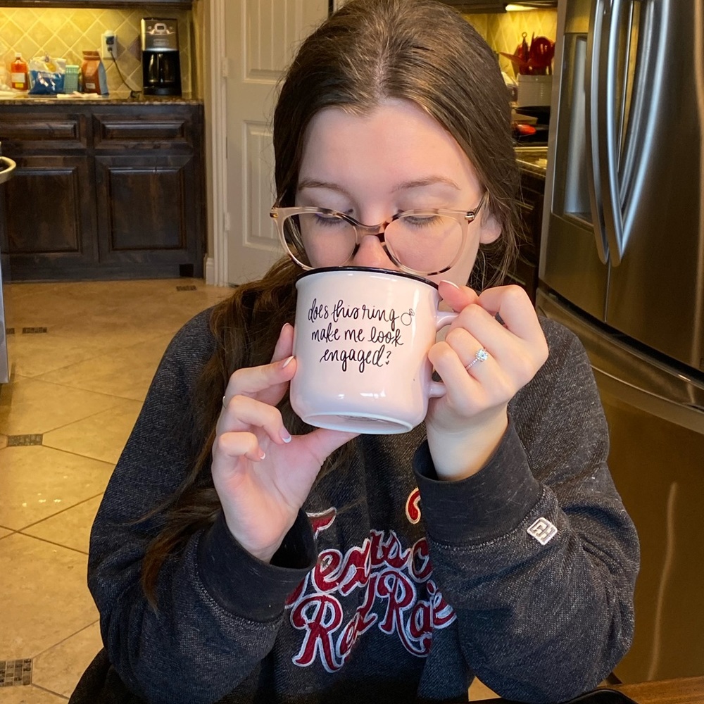 “Does this ring make me look engaged?” Light pink mug